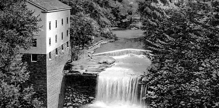 a waterfall next to a building