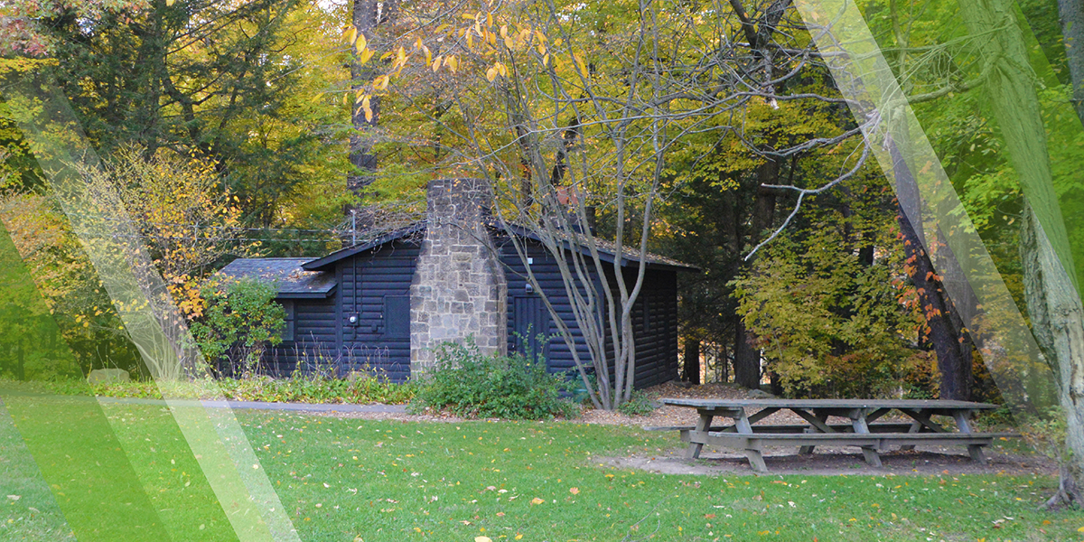 Bears Den Cabin Page Header showing the cabin in the fall, Mill Creek MetroParks