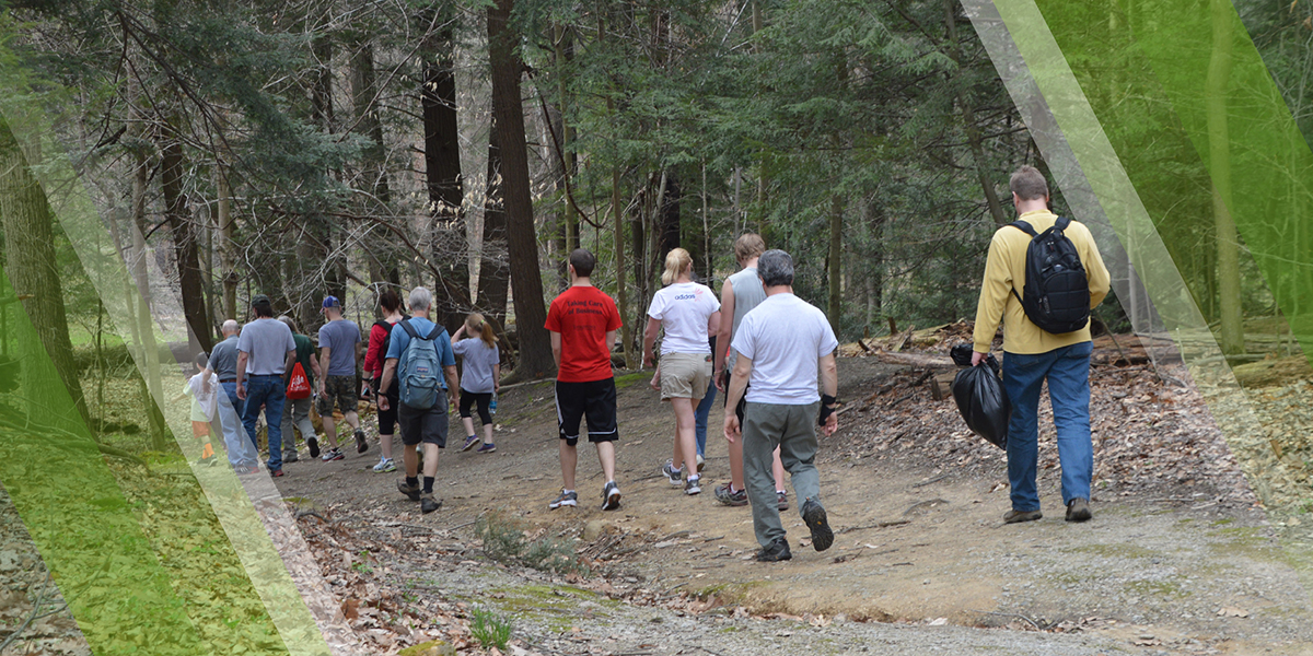 Hiking Page Header depicting hikers on a trail in Mill Creek MetroParks