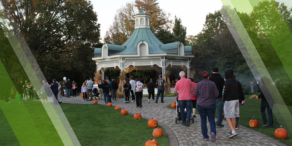 Seasonal Events Page Header showing visitors enjoying Pumpkin Walk at Twilight held every fall at Fellows Riverside Gardens in Mill Creek MetroParks