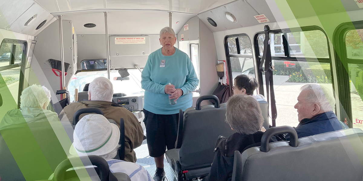 Step-On Tours Header Image showing a docent addressing a group on their van